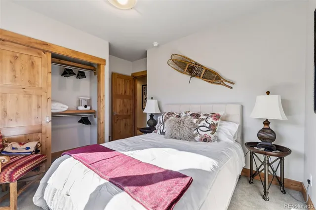 a bedroom with a bed and a mirror