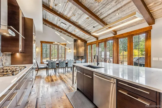 a open kitchen with lots of counter top space and stainless steel appliances