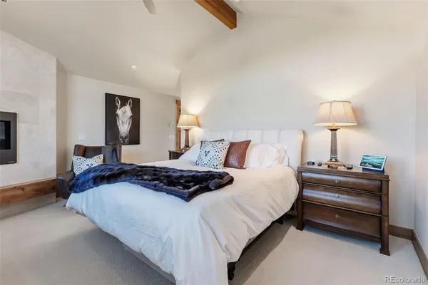 a bedroom with bed and a night stand