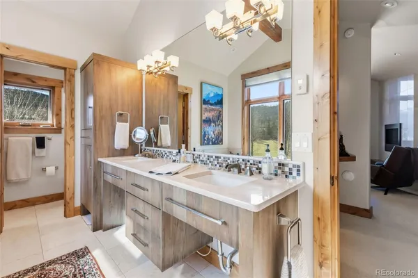 a en suite bathroom with a double vanity sink mirror and