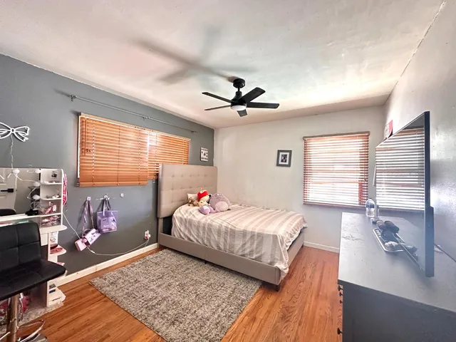 a bedroom with a bed dresser and a window