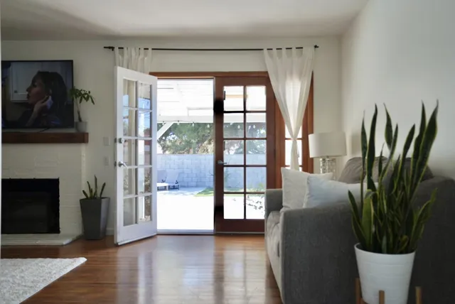 a living room with furniture and a floor to ceiling window