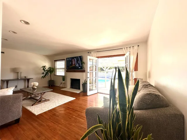 a living room with furniture a fireplace and a flat screen tv