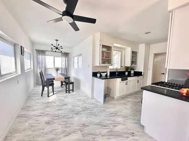 a kitchen with cabinets and chairs