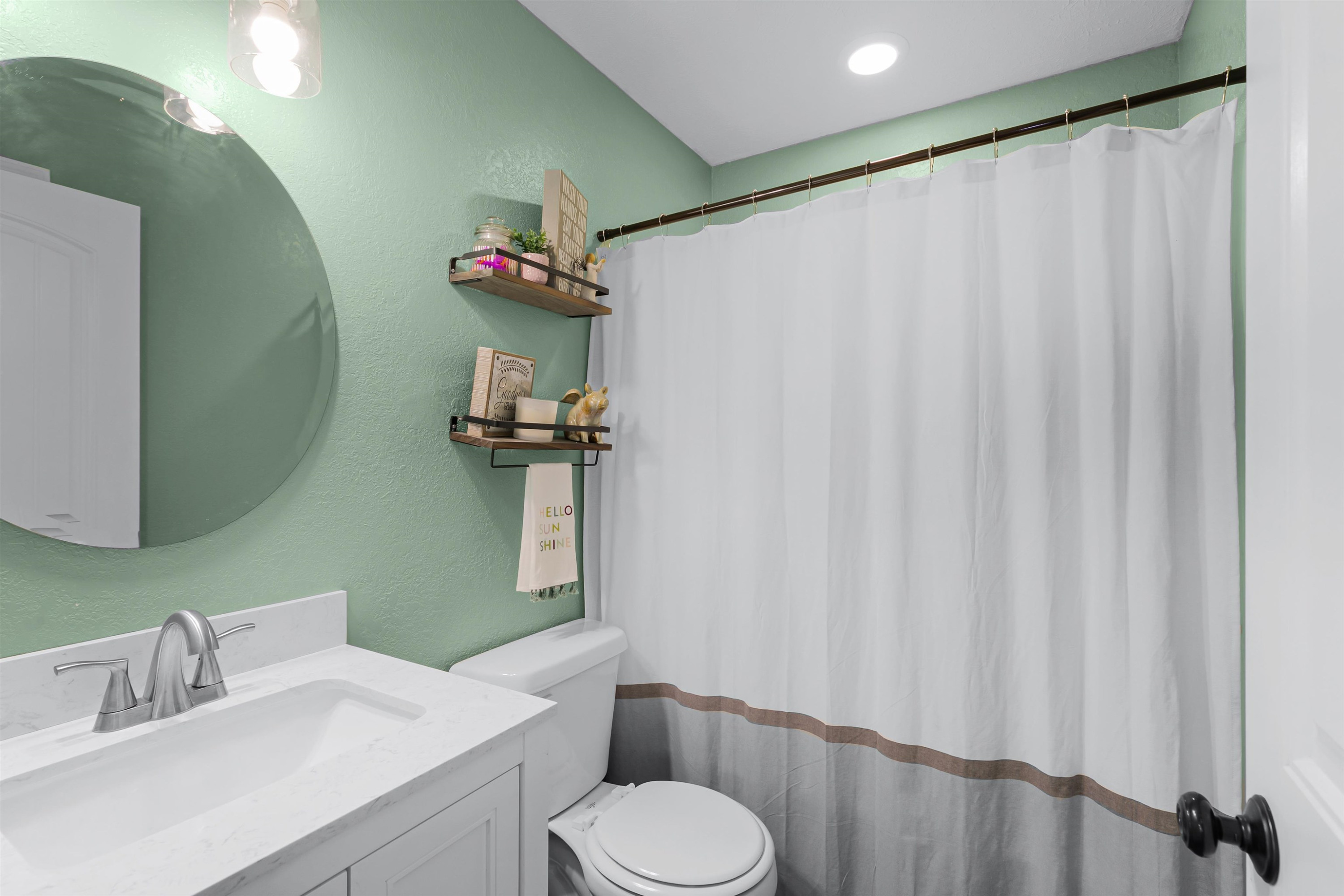 740 Corson Road Henderson, TN 38340 - Photo 14 of 15 a bathroom with a sink toilet and a mirror