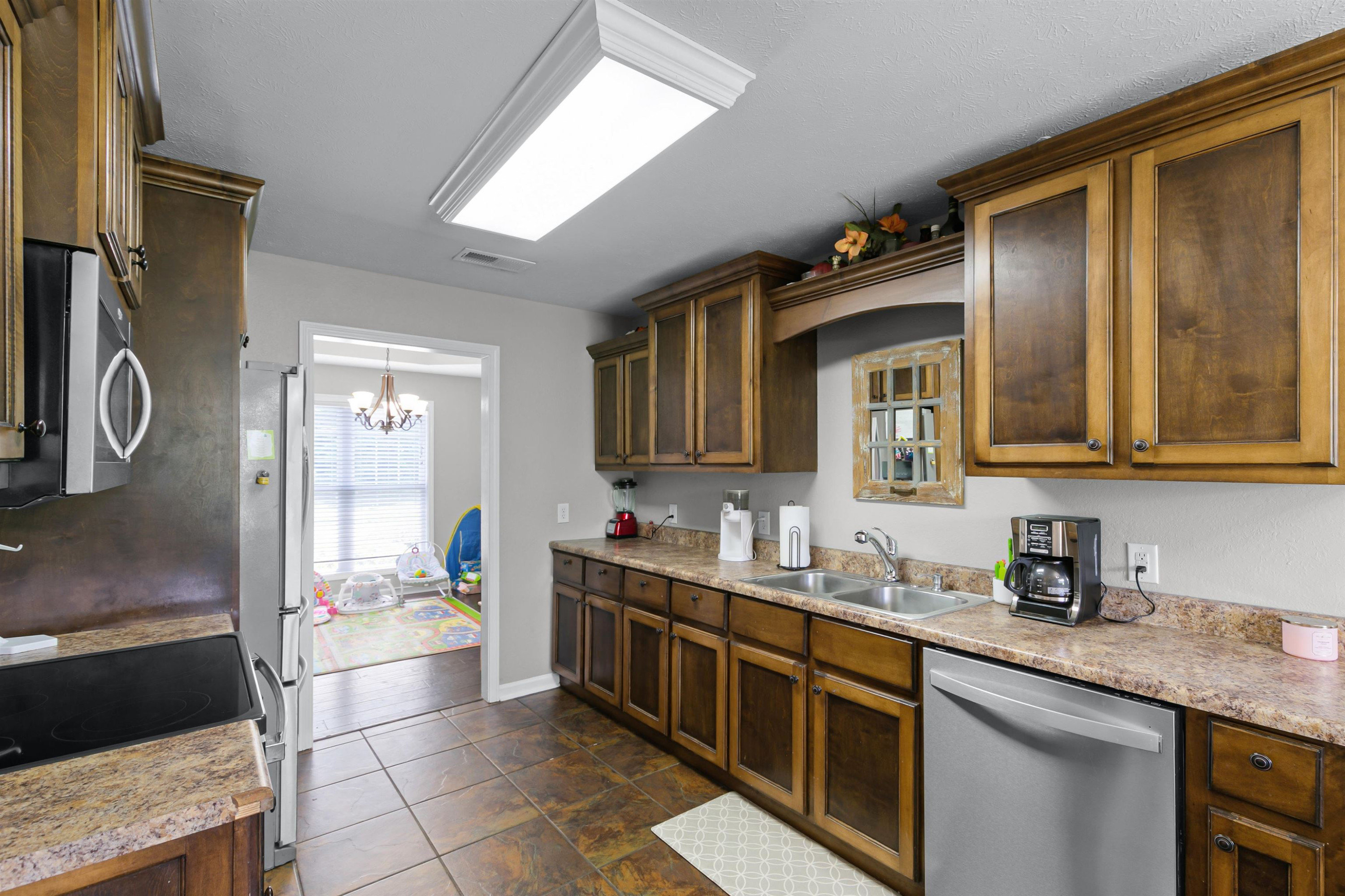 740 Corson Road Henderson, TN 38340 - Photo 8 of 15 a kitchen with a sink a stove and cabinets