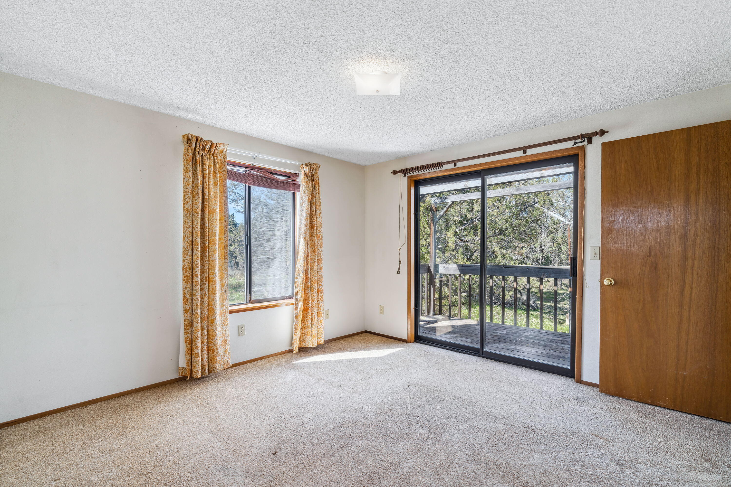 63681 Gentry Loop Bend, OR 97701 - Photo 25 of 42 25. Primary Bedroom and slide doors to d
