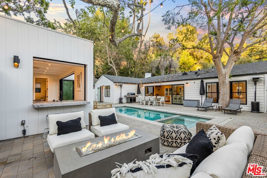 front view of house with a chairs and table in a patio