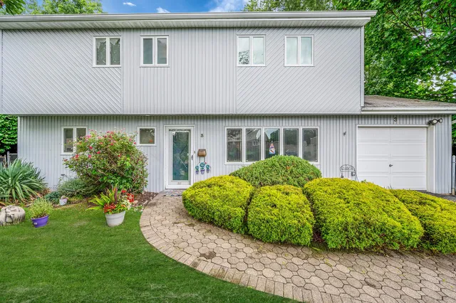 a view of a house with a yard and plants