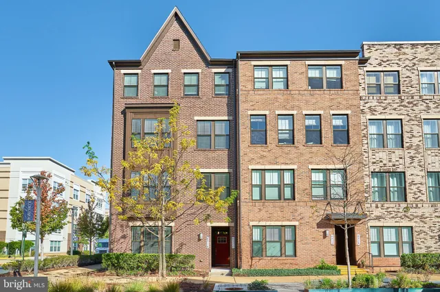 a view of a brick building next to a yard