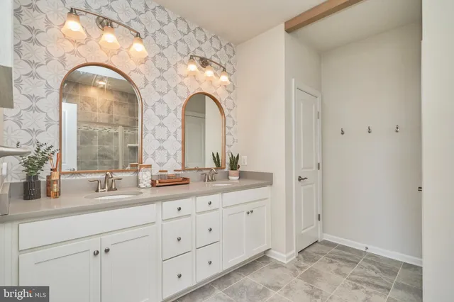 a bathroom with a double vanity sink and a mirror
