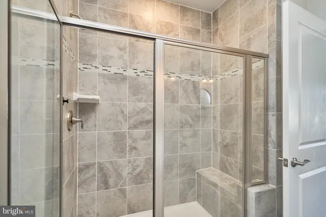 a bathroom with a glass shower door