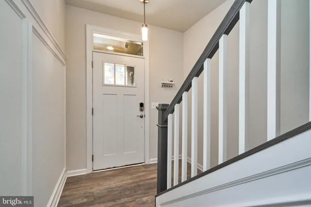 a view of an entryway with wooden floor