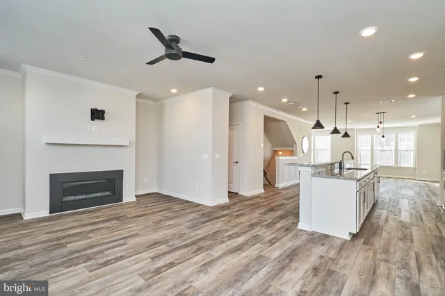 a view of a kitchen with a sink and a refrigerator
