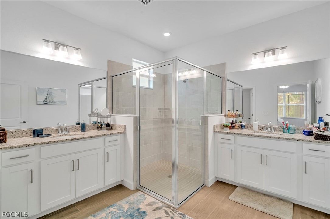 17388 Walnut Run Drive Alva, FL 33920 - Photo 19 of 24 a bathroom with a double vanity sink and mirror