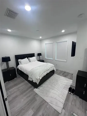 a bedroom with a bed and a television