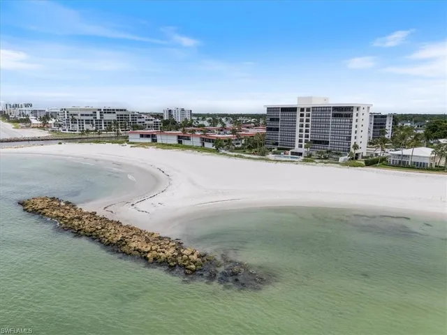 a view of a room with furniture and a large window