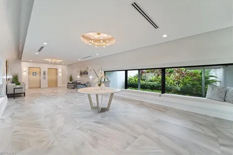a view of hallway with furniture and a large window