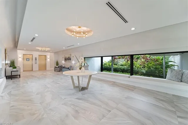 a view of hallway with furniture and a large window