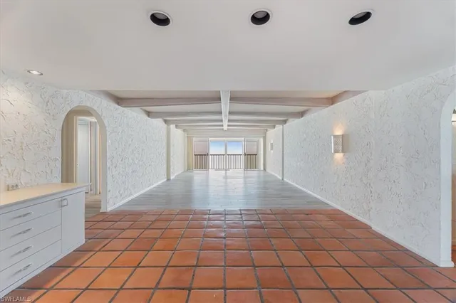 a bedroom with a bed and a lamp with mirror