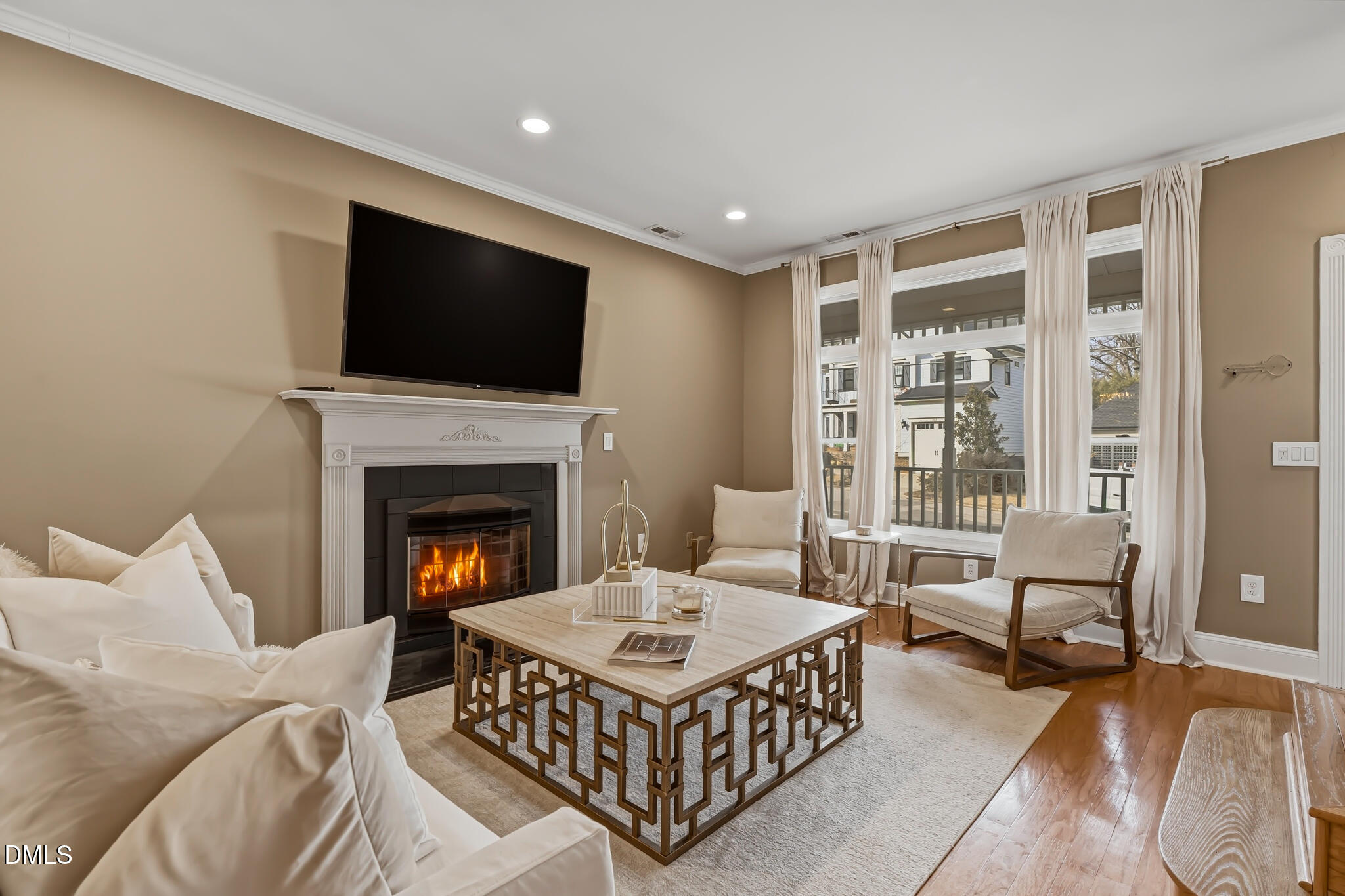 204 Georgetown Road Raleigh, NC 27608 - Photo 24 of 66 a living room with furniture a flat screen tv and a fireplace