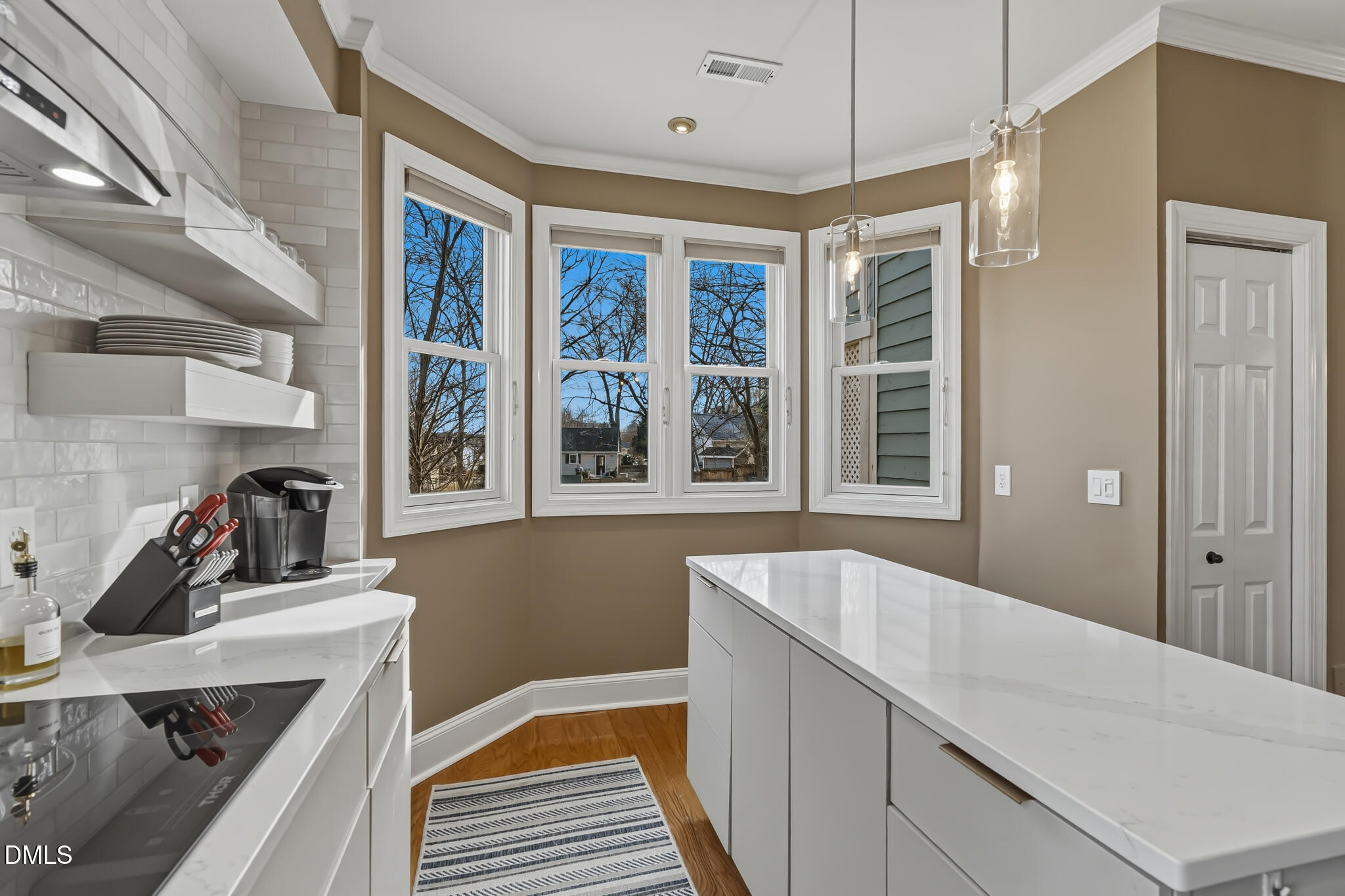 204 Georgetown Road Raleigh, NC 27608 - Photo 34 of 66 a hallway with a large window and washer dryer