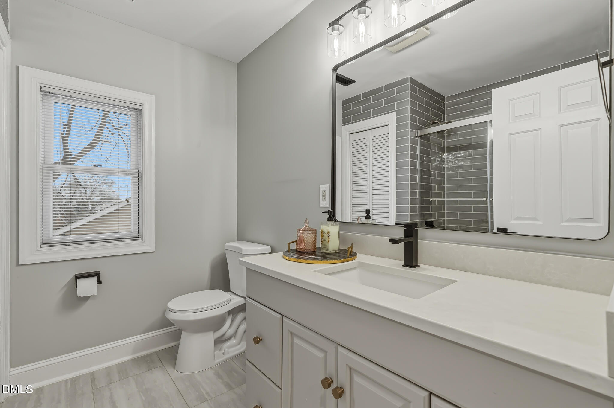 204 Georgetown Road Raleigh, NC 27608 - Photo 50 of 66 a bathroom with a granite countertop sink toilet and large mirror