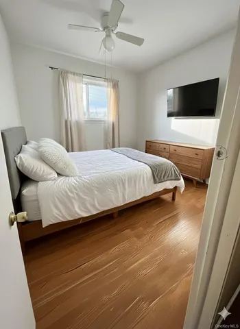 a bedroom with a bed and flat screen tv