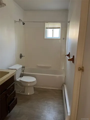 a bathroom with a toilet a sink and bathtub