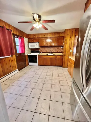 a kitchen with granite countertop a stove and a refrigerator