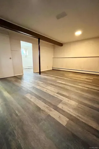 a view of a room with wooden floor