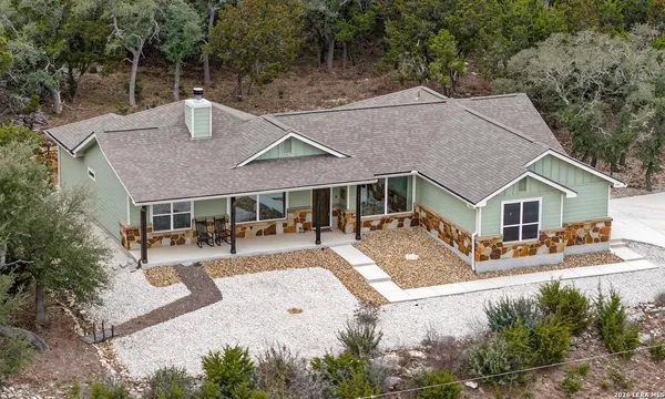 an aerial view of a house with swimming pool and porch