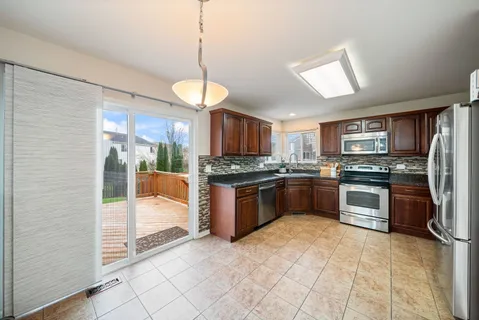 a large kitchen with cabinets and stainless steel appliances