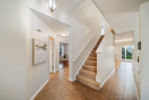 a view of staircase with lots of frames and a rug