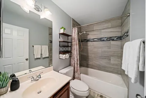 a bathroom with a sink toilet and shower