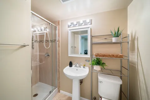 a bathroom with a sink toilet and shower
