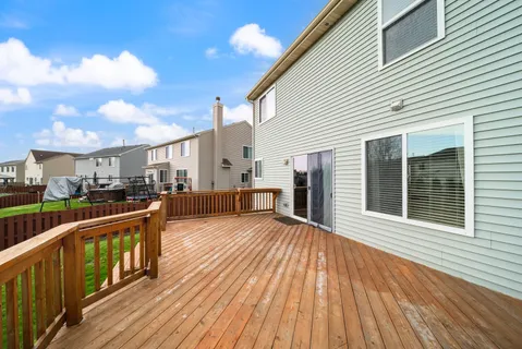 a view of a house with wooden deck