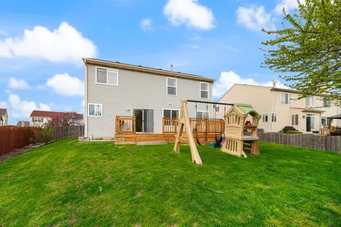 a view of a house with a backyard