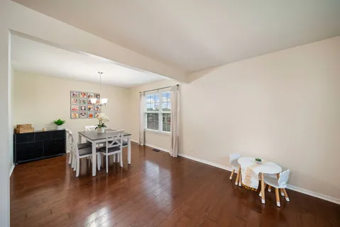 a dining room with furniture and wooden floor