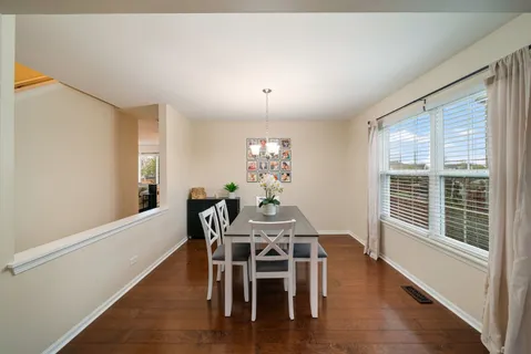 a view of a dining room with furniture window and outside view