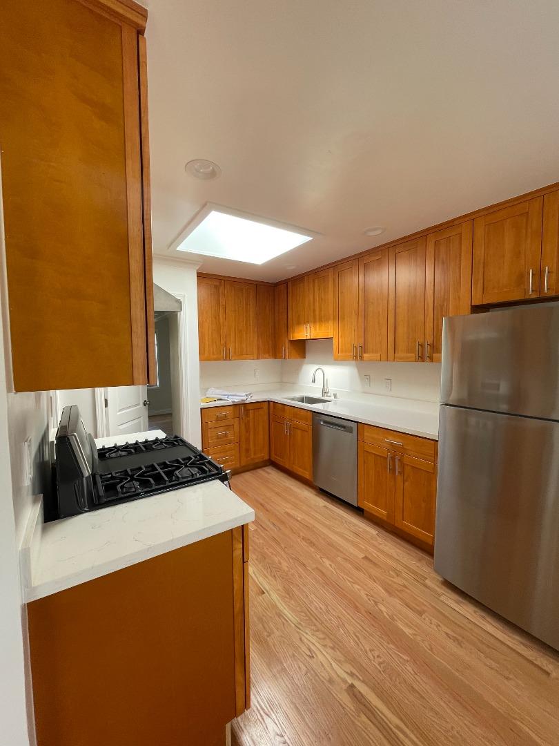 414 E Street Colma, CA 94014 - Photo 5 of 9 a kitchen with stainless steel appliances granite countertop a sink and a refrigerator