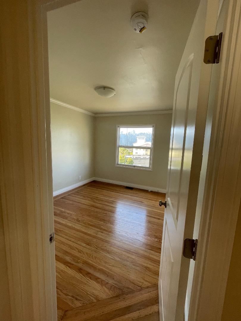414 E Street Colma, CA 94014 - Photo 6 of 9 a view of an empty room with wooden floor and a window