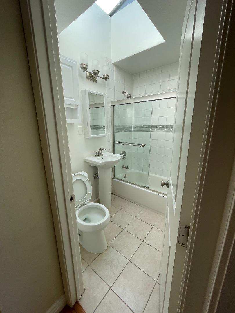 414 E Street Colma, CA 94014 - Photo 8 of 9 a bathroom with a sink a toilet and shower