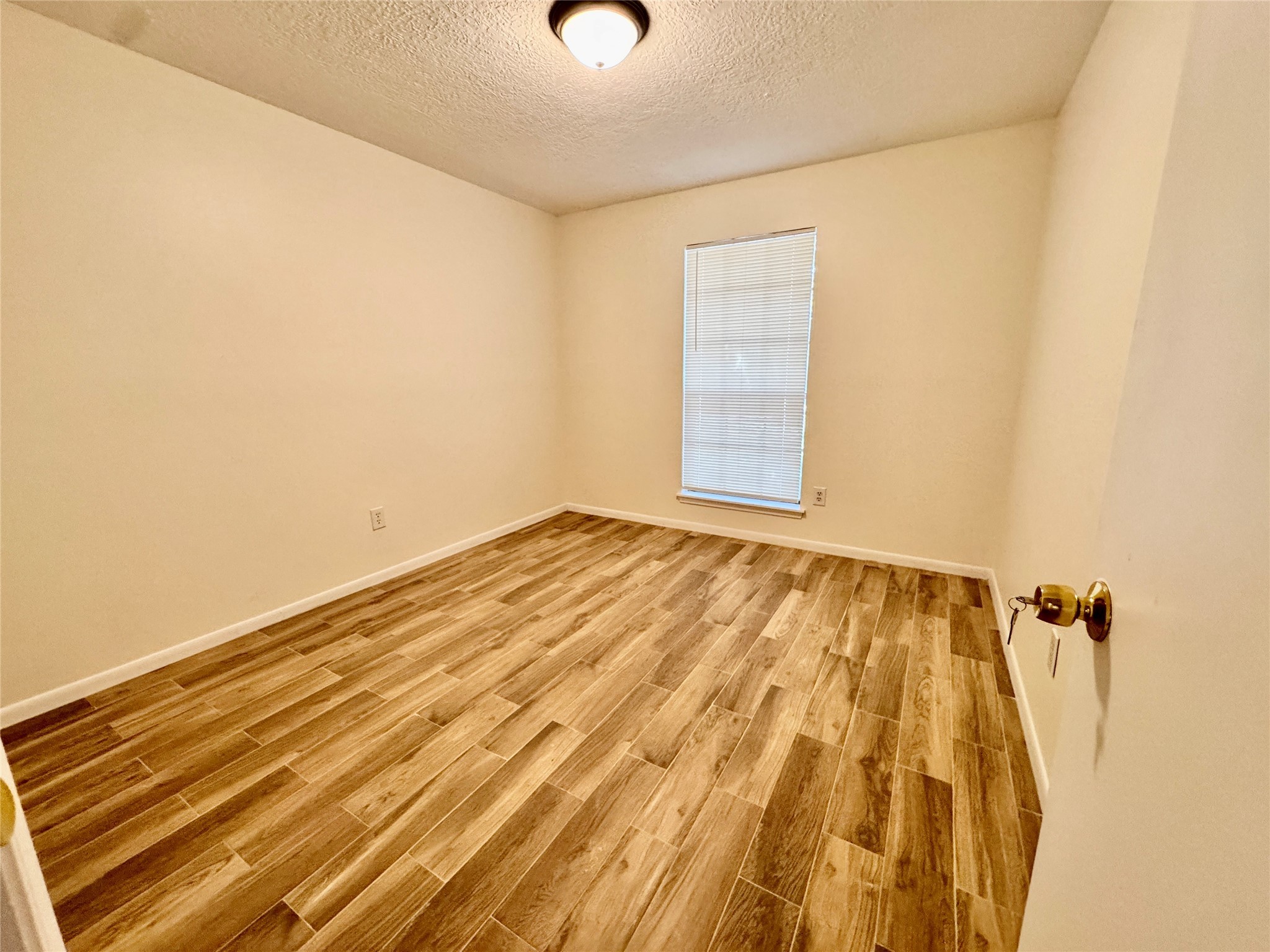 22306 Waynoka Road Katy, TX 77450 - Photo 11 of 21 a view of a room with wooden floor and a ceiling fan