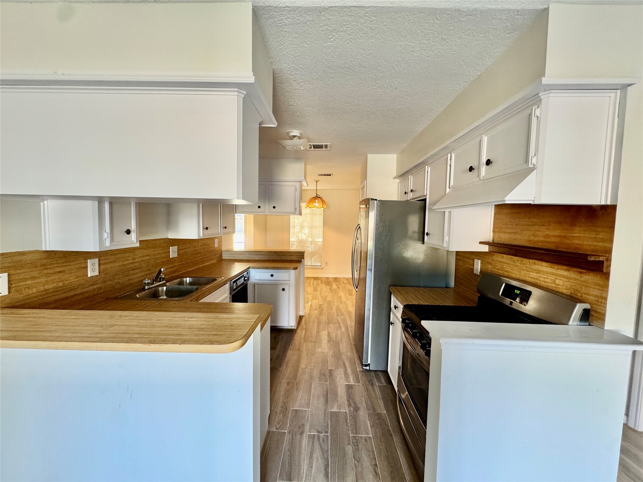 22306 Waynoka Road Katy, TX 77450 - Photo 7 of 21 a kitchen with stainless steel appliances a refrigerator stove and sink