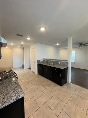 a view of a kitchen with granite countertop