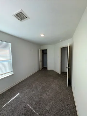 a view of an empty room and a window