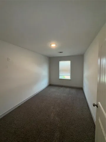 a view of a livingroom with a ceiling fan and window