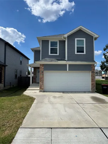 a view of a house with a yard and garage