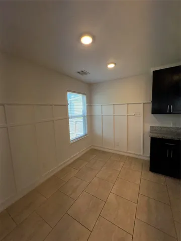 a spacious bathroom with a granite countertop bathtub sink and a mirror